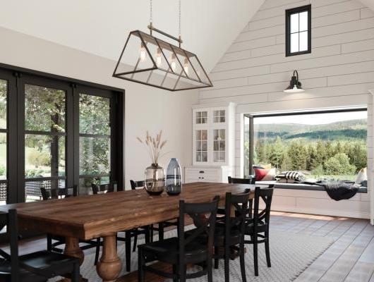 Remodeled dining area with cathedral ceilings big farm table and big scenic windows